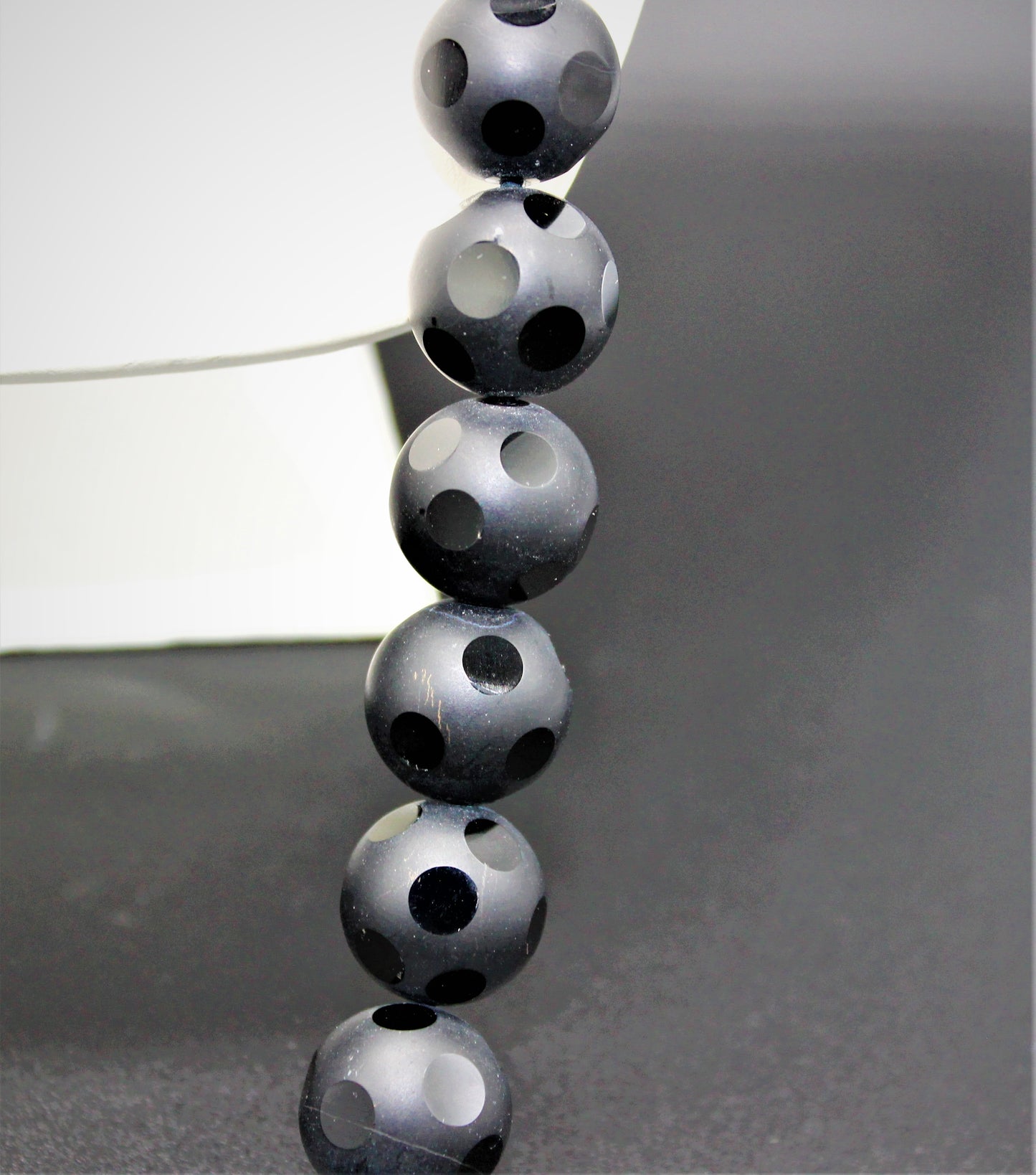 Dalmatian Cut Onyx Beads with design woven clasp.